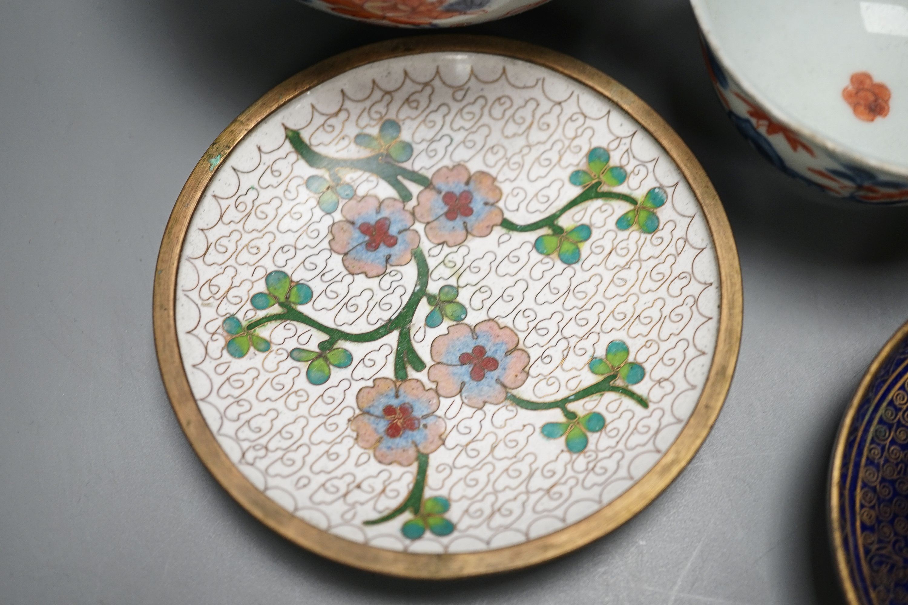 A collection of 18th century Chinese export porcelain tea bowls or cups and two cloisonné enamel dishes